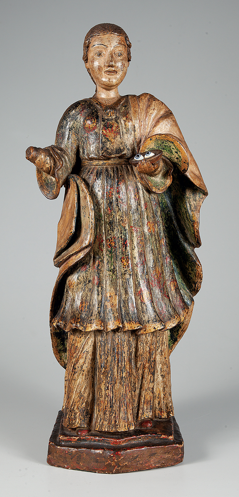Santa Luzia, belíssima imagem em barro policromado falta mão direita medindo 59 cm. de altura, peça de coleção ` Brasil ` Séc. XVII/ XIX.